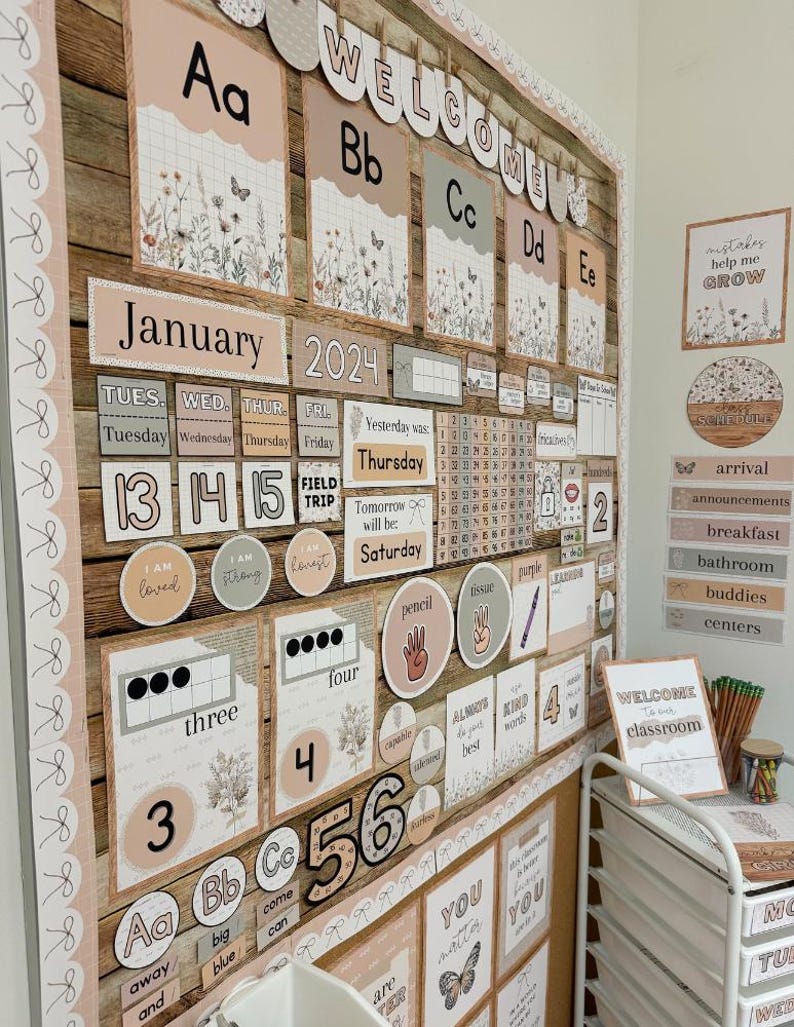 May include: A classroom bulletin board set featuring a neutral color palette with floral and butterfly illustrations. The display includes alphabet cards, a calendar for January 2024, number charts, daily schedule labels, and motivational signs with text.