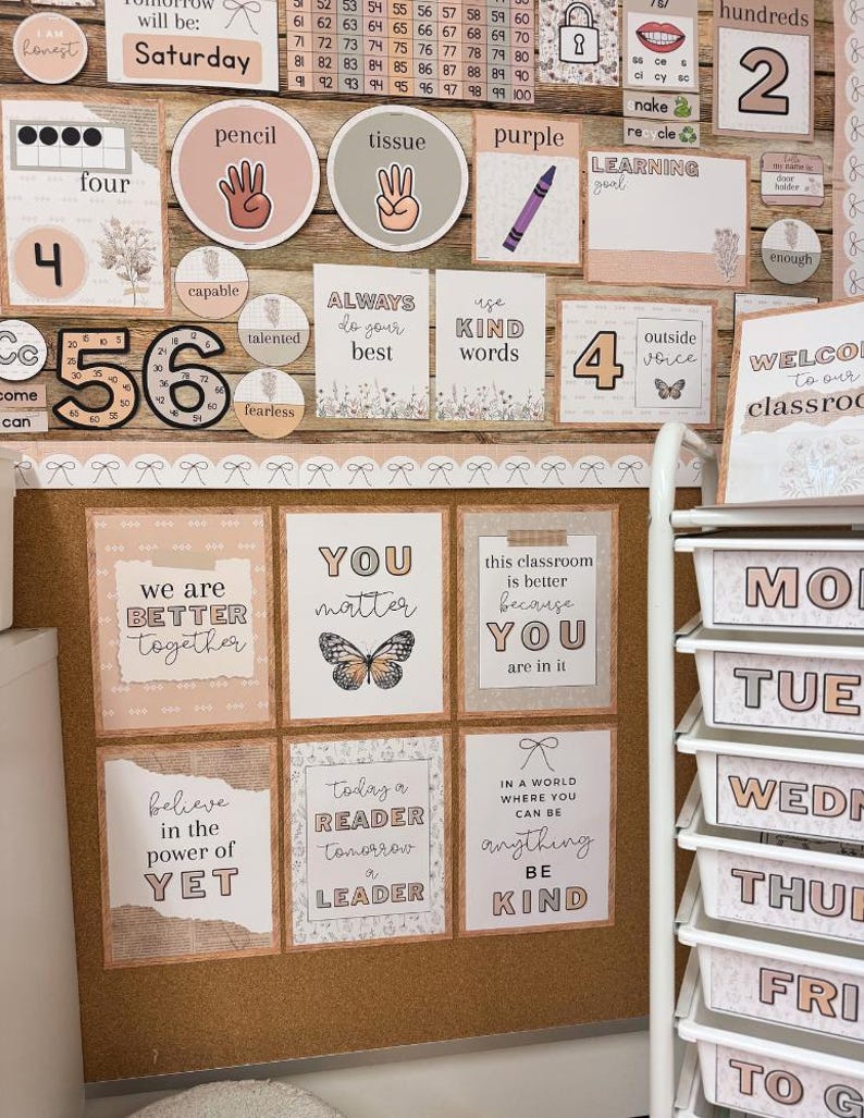 May include: A classroom bulletin board display featuring educational posters, number charts, and motivational signs in a neutral color palette. The decor includes text-based prints, butterfly illustrations, and a white rolling cart with labeled drawers.