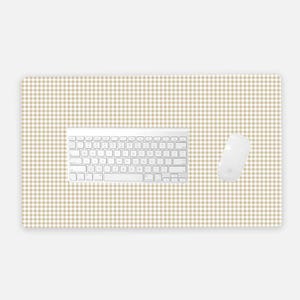 May include: A computer desk mat with a beige and white gingham pattern. A white keyboard and mouse are on the mat. The mat is rectangular and designed to protect a desk surface.