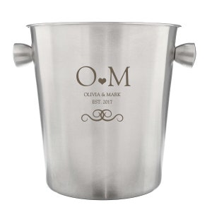 May include: Silver ice bucket with handles and engraved initials "O.M." with the text "Olivia & Mark Est. 2017" and a decorative swirl design.