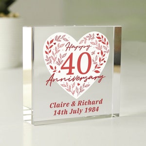 May include: A clear glass cube with a red heart design that says "Happy 40th Anniversary" with red floral accents. The names Claire & Richard and the date 14th July 1984 are printed below the heart.