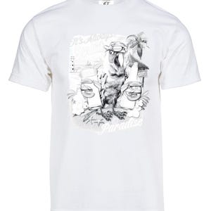 May include: White t-shirt with a black and white graphic print of a parrot holding two drinks. The text "It's Always 5 o'clock Somewhere" and "Paradise" are printed on the shirt.