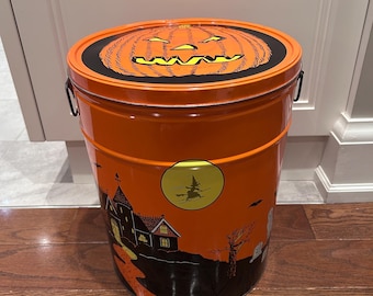 vintage lithographed metal Halloween tin container with a lid, featuring classic ghost, skeleton, and jack-o'-lantern graphics 1980s
