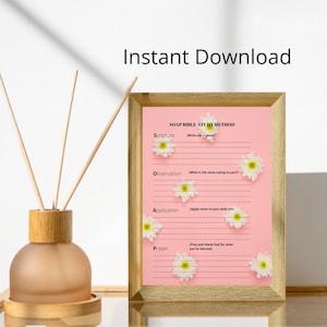 May include: A pink printable SOAP Bible study method chart with white flowers and gold frame. The chart includes sections for Scripture, Observation, Application, and Prayer. The words "Instant Download" are at the top.