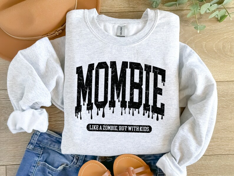 May include: A gray sweatshirt with the text "MOMBIE LIKE A ZOMBIE BUT WITH KIDS" in black.