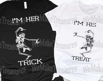 May include: Two black and white t-shirts with skeleton graphics and text. The black shirt says "I'm Her Trick" and the white shirt says "I'm His Treat".