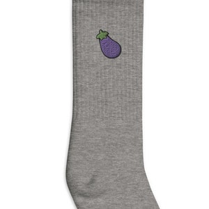 May include: Gray crew socks with an embroidered eggplant design.