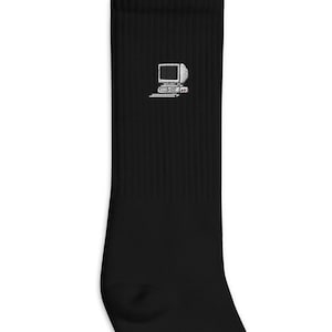 May include: Black crew socks with a white computer icon on the front.