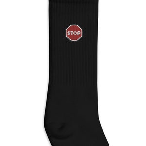 May include: Black crew socks with a red stop sign embroidered on the front.