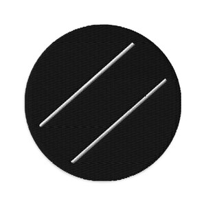 May include: A black circular patch with two parallel white diagonal lines embroidered across its surface. The patch has a textured appearance, suggesting a fabric material.