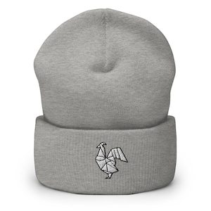 May include: Gray beanie with a white origami rooster embroidered on the front.