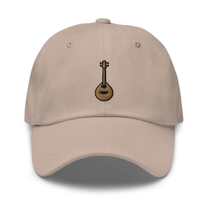 May include: A beige baseball cap with an embroidered brown and gold mandolin.