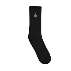 May include: Black crew socks with a small gray embroidered design on the front.