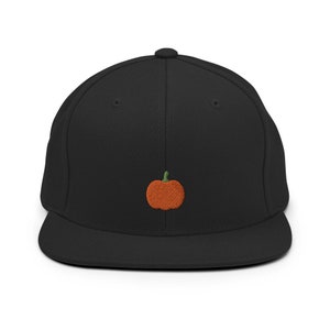 May include: A black and orange embroidered pumpkin on a black fitted baseball cap.