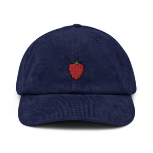 Könnte beinhalten: Eine marineblaue Baseballkappe aus Cord mit einem gestickten roten Himbeer-Design.