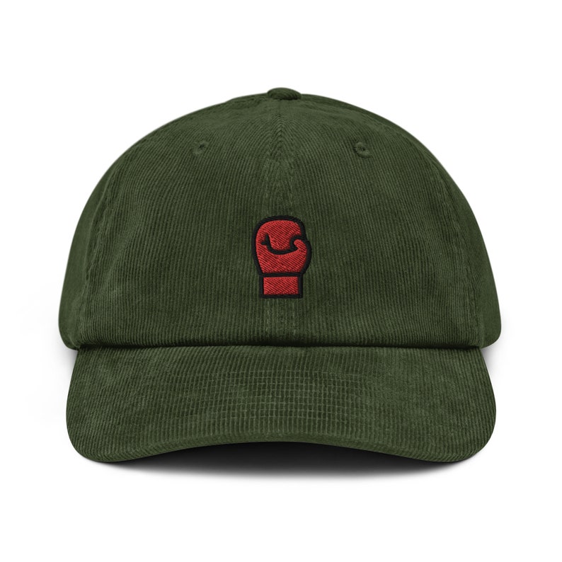 May include: A green corduroy baseball cap with a red boxing glove embroidered on the front.