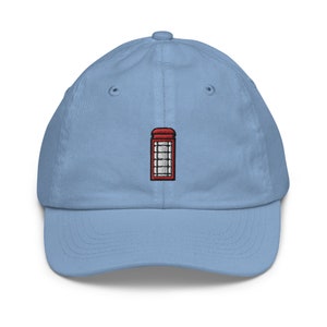 May include: A light blue baseball cap with an embroidered red telephone booth on the front.