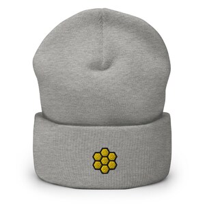 May include: Gray beanie with a yellow honeycomb design embroidered on the front.