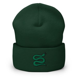 May include: A dark green beanie with a green snake embroidered on the front.