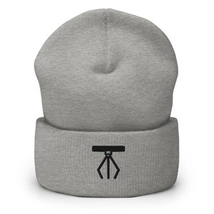 May include: Gray beanie with a black embroidered claw design.
