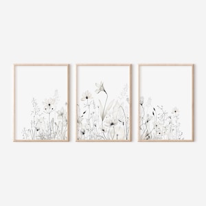 May include: A set of three framed prints featuring a watercolor illustration of white flowers and greenery on a white background.