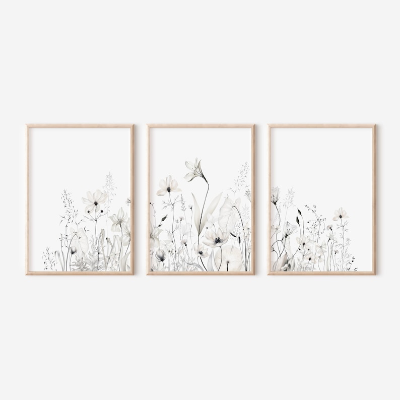 May include: A set of three framed prints featuring a watercolor illustration of white flowers and greenery on a white background.