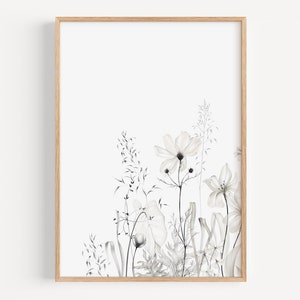 May include: A black and white watercolor print of a floral arrangement with delicate flowers and grasses. The print is framed in a light wood frame.