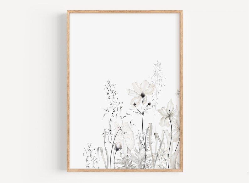 May include: A black and white watercolor print of a floral arrangement with delicate flowers and grasses. The print is framed in a light wood frame.