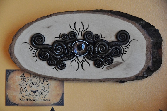 A hand-painted wooden wall creature made entirely of expressive eyes — unsettling, folkloric, and utterly one-of-a-kind wall art.