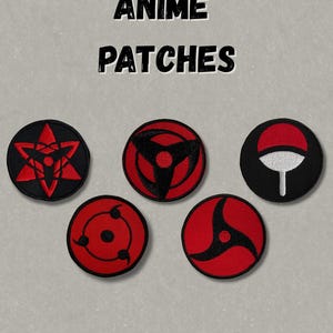 May include: Five circular embroidered patches featuring red and black graphic designs. The text ANIME PATCHES is printed in black above the patches. The designs include various stylised eye-like patterns and a red and white fan-shaped emblem.