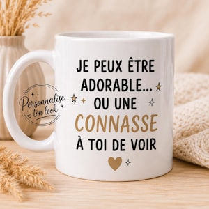 Peut inclure: Mug en céramique blanche avec l'inscription "JE PEUX ÊTRE ADORABLE... OU UNE CONNASSE À TOI DE VOIR" en noir et marron. La tasse a une anse et un motif de cœur et d'étoile.