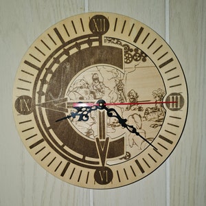 May include: A round wooden clock with a laser-etched design. The clock face features Roman numerals, a detailed illustration, and black clock hands with a red second hand. The clock is made of light-colored wood.
