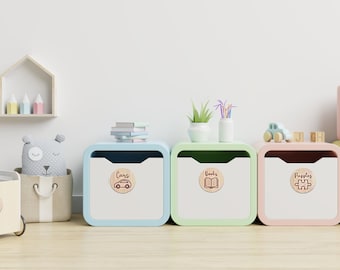 May include: Four colorful storage bins with wooden labels for a child's room. The labels read "Cars", "Books", "Puzzles", and "Small Toys".