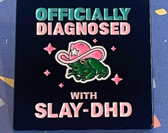 Officially diagnosed with Slay DHD cowboy frog enamel pin