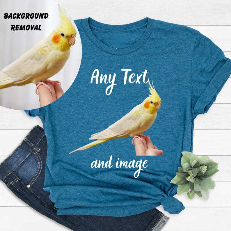 a blue t-shirt with a yellow bird perched on it, along with a pair of jeans and a small green plant.