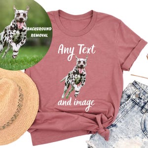a pink t-shirt with a Dalmatian dog graphic and the text "Any Text and image" printed on it. The t-shirt is placed on a white background, and there is a straw hat and denim jeans visible in the image.