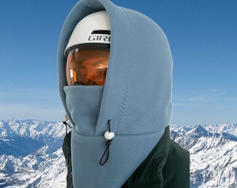 May include: A light blue fleece ski mask with a white helmet and a black drawstring. The mask has a hood and a face covering.