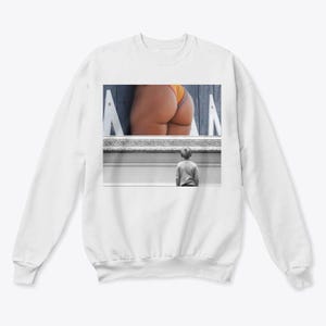 May include: White sweatshirt featuring a framed image of a person's lower body in a swimsuit and a child looking at the image. The image within the frame is in color, while the rest of the image is in black and white.