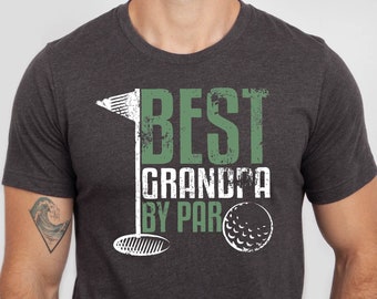 May include: A dark heather grey t-shirt with a green and white graphic that says "Best Grandpa By Par" with a golf club and golf ball.