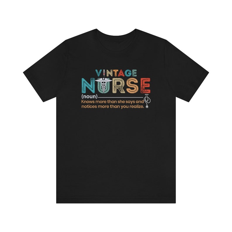 May include: Black t-shirt with a vintage-style graphic that says "Vintage Nurse (noun) Knows more than she says and notices more than you realize."