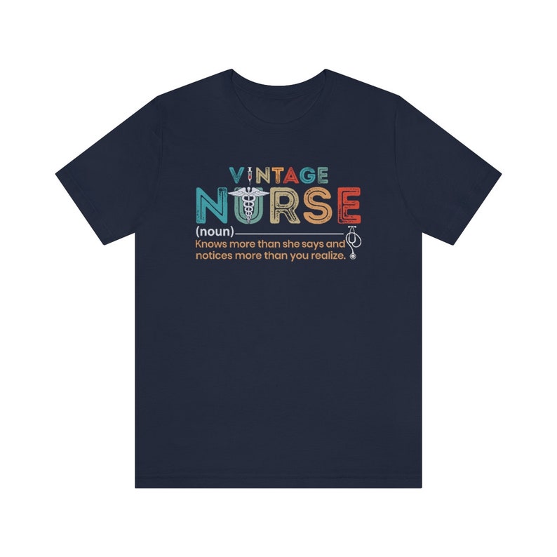 May include: A navy blue t-shirt with a vintage-style graphic that reads "VINTAGE NURSE (noun) Knows more than she says and notices more than you realize."