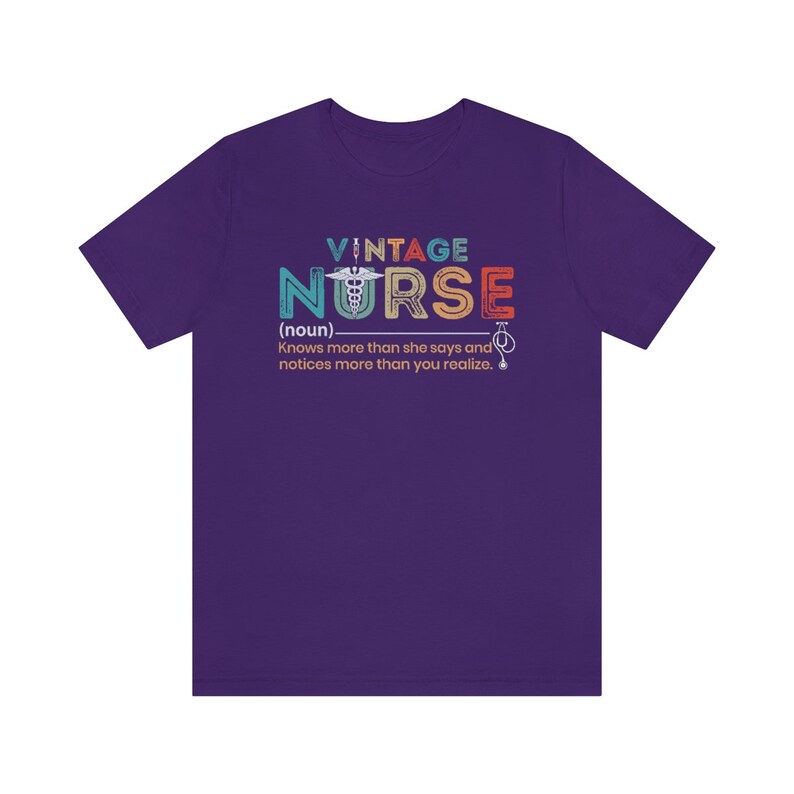 May include: Purple t-shirt with a vintage-style graphic that says "Vintage Nurse (noun) Knows more than she says and notices more than you realize."