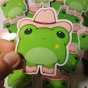 Adesivo lucido con cappello rosa da cowboy e rana