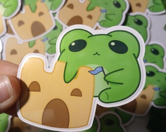 Pegatina brillante de rana de castillo de arena de playa