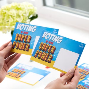 May include: A set of blue and yellow postcards with the text "Voting is your superpower" in a comic book style font. The postcards have a blank space for a stamp and address.