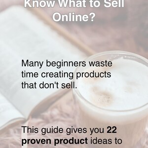 May include: Image with text: "Struggling to Know What to Sell Online?" and "This guide gives you 22 proven product ideas to help you start faster." A glass of coffee sits next to an open book on a soft, textured surface.