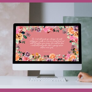 May include: A computer screen displaying a pink floral wallpaper with a Bible verse from Isaiah 58:11. The verse reads: "The Lord will guide you always; He will satisfy your needs in a sun-scorched land and will strengthen your frame. You will be like a well-watered garden, like a spring whose waters never fail."