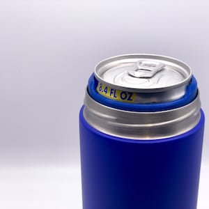 May include: A blue and silver can cooler with a stainless steel liner. The cooler has a blue silicone sleeve and a silver lid. The can cooler is designed to hold a 8.4 fl oz can.