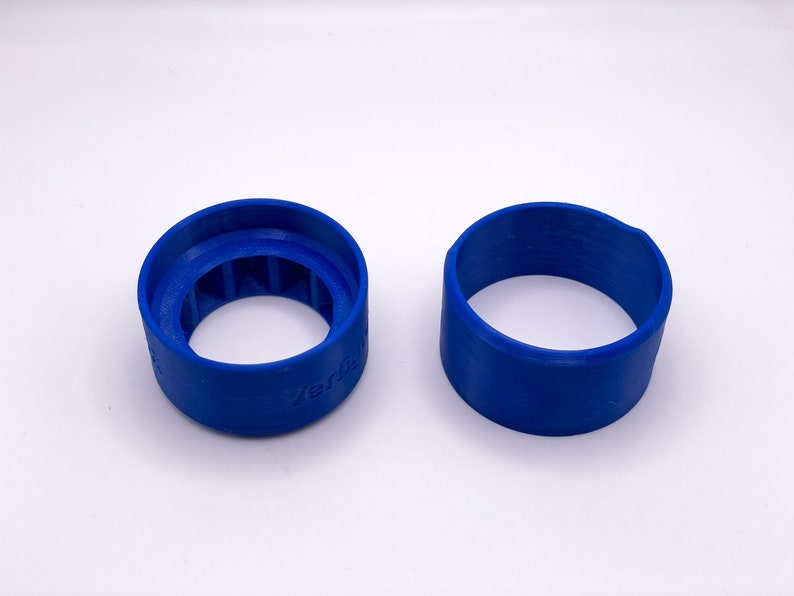May include: Two blue plastic rings, one with a textured inner surface and the word "Verti" printed on the side.