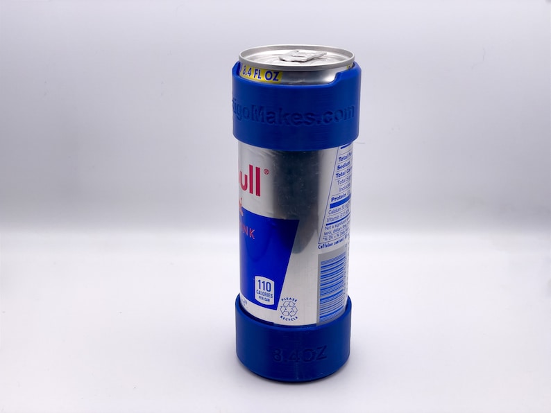 May include: A blue can holder with the text "gogoMakes.com" printed on it. The holder is around a silver can of Red Bull energy drink. The can is 16.9 fl oz and has 110 calories per can.